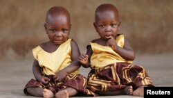 Identical twins Taiwo Adejare and Kehinde Adejare pose for a picture in Igbo Ora, Oyo State, Nigeria April 4, 2019. Picture taken April 4, 2019. REUTERS/Afolabi Sotunde