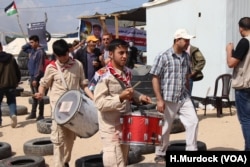 Boys play the drums to excite protesters who say that even after 70 years of displacement, they still want to return to their homes in the Gaza Strip, May 14, 2018.