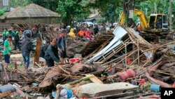 Residents inspect a house damaged by a tsunami, in Carita, Indonesia, Dec. 23, 2018. 