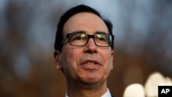 FILE - Treasury Secretary Steven Mnuchin talks with reporters at the White House, in Washington, Dec. 3, 2018. 