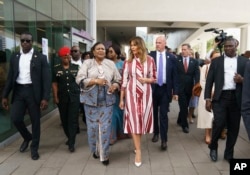 First lady Melania Trump and Ghana's first lady Rebecca Akufo-Addo walk to their vehicles as they leave Greater Accra Regional Hospital in Accra, Ghana, Oct. 2, 2018.