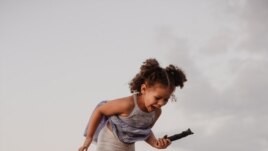 Father and daughter playing by the water.