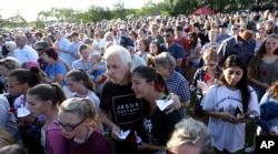 Mourners gather during a prayer vigil following a shooting at Santa Fe High School in Santa Fe, Texas, May 18, 2018.