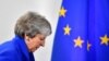 May Hangs On, Despite Calls to Quit