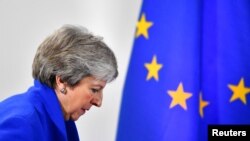 FILE - Britain's Prime Minister Theresa May arrives for a news conference in Brussels, Belgium, Nov. 25, 2018. 