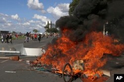 Demonstrators create a flaming barricade with chairs taken from the Ministry of Agriculture during an anti-government protest in Brasilia, Brazil, May 24, 2017.