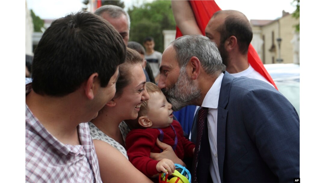 Armenia's Prime Minister Nikol Pashinian kisses a baby after a news conference in the capital Stepanakert of the separatist Nagorno-Karabakh region, May 9, 2018.