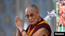 FILE - Exiled Tibetan spiritual leader, the Dalai Lama, speaks to his followers at the Gaden Jangtse Thoesam Norling Monastery in Mundgod in the southern Indian state of Karnataka, Dec.23, 2014.
