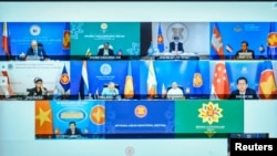 Foreign ministers and representatives of the Association of Southeast Asian Nations (ASEAN) are seen on a screen during an informal meeting, in Putrajaya, Malaysia, on March 2, 2021. Courtesy of Malaysian (Foreign Ministry/Handout via REUTERS)