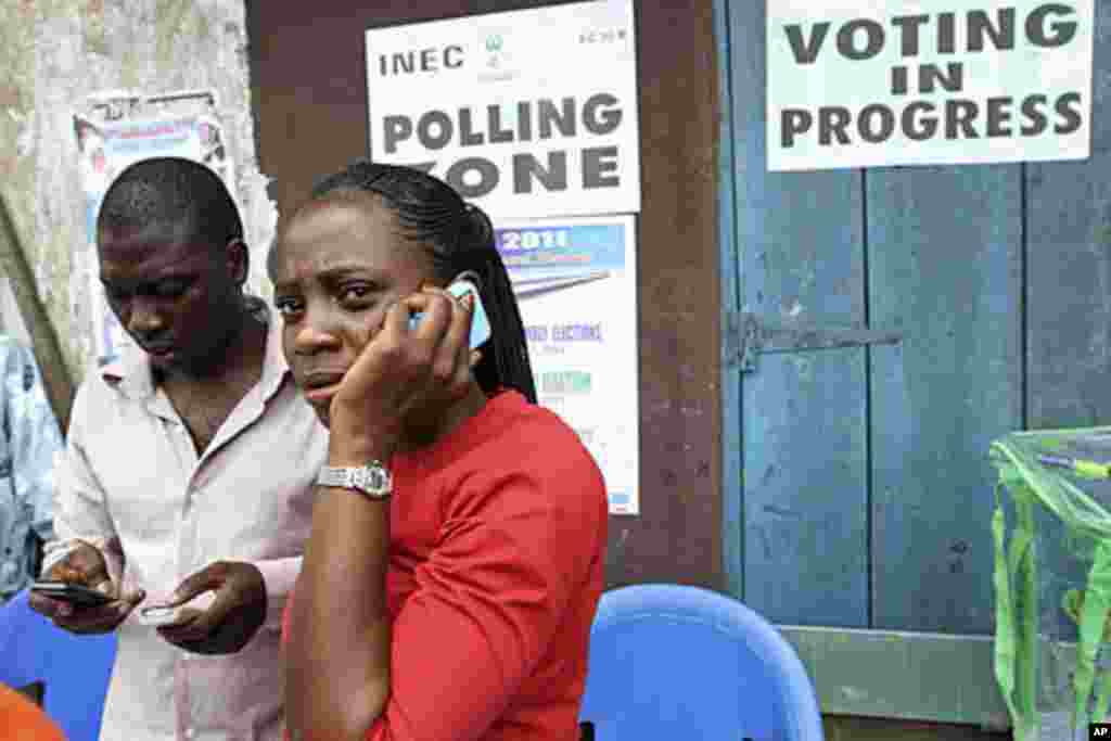 An election officer in Nigeria's commercial capital, Lagos, makes a phone call after the postponement of parliamentary elections, April 2, 2011