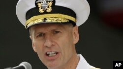 FILE - US Navy Vice Adm. Joseph Aucoin, commander of the 7th Fleet, delivers a speech in front of the nuclear-powered aircraft carrier USS Ronald Reagan in Yokosuka, Japan.