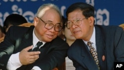 Chairman of the Cambodian People's Party Chea Sim, left, talks with Second Prime Minister Hun Sen during a meeting at their headquarters in Phnom Penh Wednesday, Jan. 7, 1998. Some 10,000 supporters celebrate to mark the 19th anniversary of the overthrow 