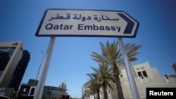 A sign indicating a route to Qatar embassy is seen in Manama, Bahrain, June 5, 2017. 