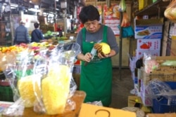 A vendor prepares pineapples at a fruit stall in a market in Taipei, Taiwan, March 5, 2021. REUTERS/Ann Wang