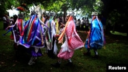 Traditional dancers participate in a traditional ceremony to commemorate the International Day of the World's Indigenous People in Izalco, El Salvador, August 9, 2016. 