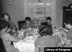 Farm family at dinner. (Library of Congress)