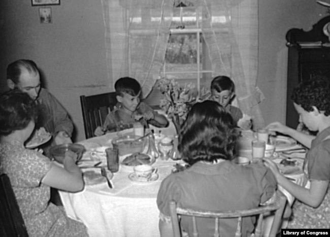 Farm family at dinner. (Library of Congress)