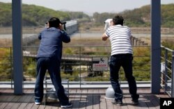 Visitors look at the north side at the Imjingak Pavilion near the border with North Korea, in Paju, South Korea, April 24, 2016.