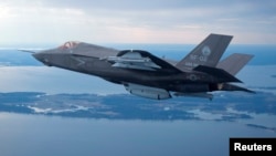 FILE - The U.S. Marine Corps version of Lockheed Martin's F-35 Joint Strike Fighter flies over the Atlantic test range at Patuxent River Naval Air Systems Command in Maryland in a Feb. 22, 2012.