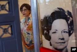 Rosa Cardoso, a lawyer who led Brazil's national truth commission talks, as she stands next to a photo of Lyda Monteiro da Silva, who was the secretary of the Order of Attorneys of Brazil and who was killed while opening a letter bomb addressed for the president of the Order in 1980, in Rio de Janeiro, March 26, 2019.