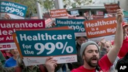 FILE - Supporters of single-payer health care march to the Capitol in Sacramento, Calif., April 26, 2017.