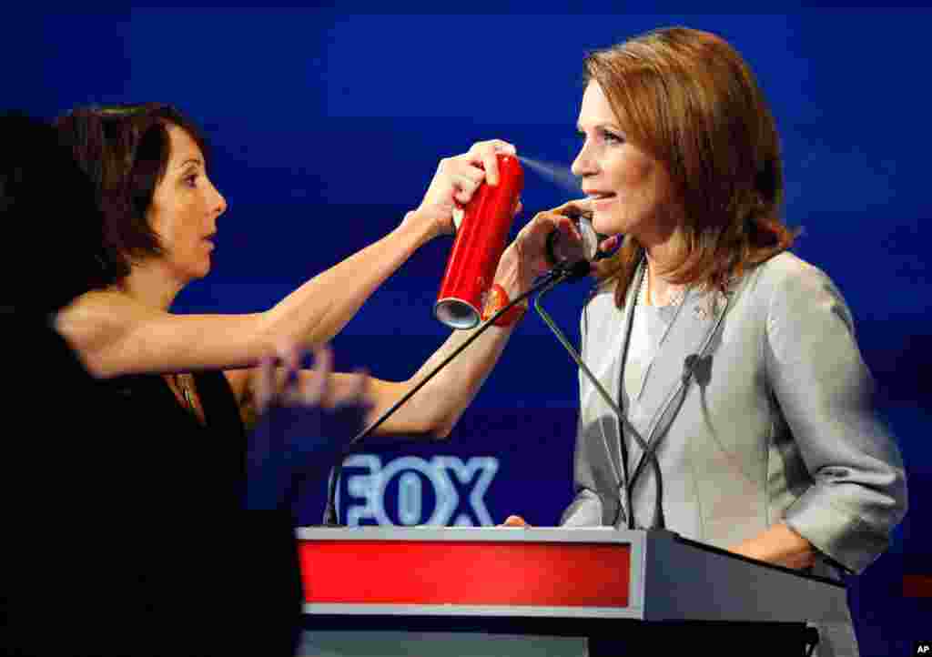 U.S. Republican presidential candidate Michele Bachmann receives styling during a commercial break during the Republican presidential debate in Ames, Iowa, August 11, 2011. (Reuters)