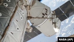 FILE - The SpaceX Dragon spacecraft is shown docked at the International Space Station.