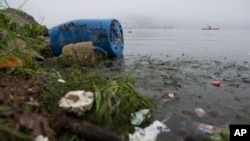 FILE - Trash litters Rodrigo de Freitas Lake in Rio de Janeiro, Brazil, Nov. 10, 2015. 