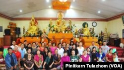 A group of local Laotian and Thai supporters greet Phra Sutham Nateetong, the monk who is walking for peace across America at Wat Lao Samakky Temple, Fort Wayne, Indiana June 9, 2019.