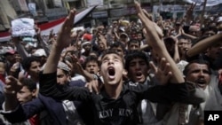 An anti-government protestor, center, reacts during a demonstration demanding the resignation of Yemeni President Ali Abdullah Saleh, in Sanaa, Yemen, March 6, 2011