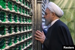 ranian President Hassan Rouhani visits the shrine of Imam Moussa al-Kadhim in Baghdad, Iraq, March 11, 2019.