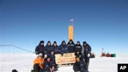Russian researchers at the Vostok station in Antarctica after reaching subglacial Lake Vostok. Scientists hold a sign reading "05.02.12, Vostok station, boreshaft 5gr, lake at depth 3769.3 metres."