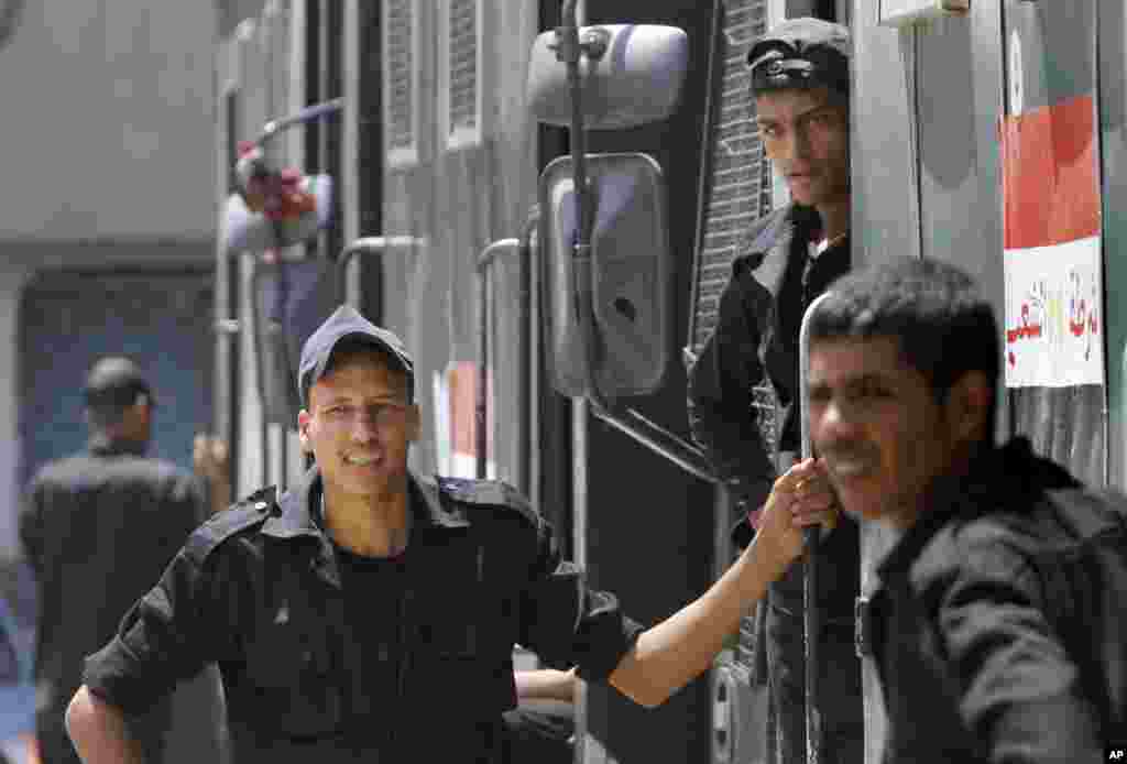 Police stand outside of their vehicle in Cairo, August 20, 2013.