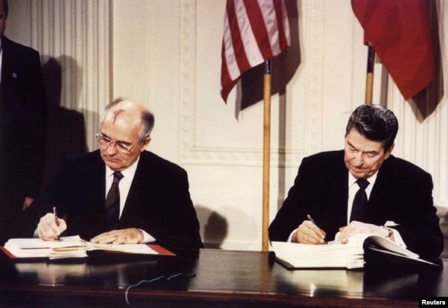 FILE - U.S. President Ronald Reagan and Soviet President Mikhail Gorbachev sign the Intermediate-range Nuclear Forces Treaty at the White House, Dec. 8 1987.
