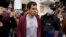 FILE - Police officers and journalists surround Roman Dobrokhotov in Moscow, July 28, 2021.