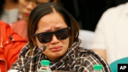 A pregnant witness, the live-in partner of JP Bertes, an alleged drug-pusher who was killed while in police custody, tearfully recounts their ordeal as she testifies before the Philippine Senate which is probing the extra judicial killings related to President Rodrigo Duterte's "War on Drugs" Monday, Aug. 22, 2016 in suburban Pasay city, south of Manila, Philippines.