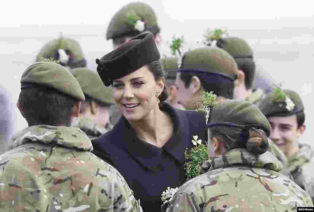 Britain's Kate, the Duchess of Cambridge meets cadets during a visit to the 1st Battalion Irish Guards at the St. Patrick's Day Parade at Mons Barracks, Aldershot, in England, March 17, 2015.