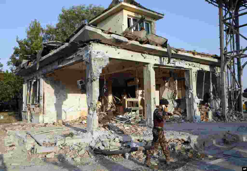 A Turkish special forces policemen walks in front of their damaged base, which was attacked by the Turkish warplanes during the failed military coup last Friday, in Ankara.