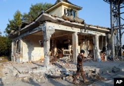 A Turkish special forces policemen walks in front of their damaged base, which was attacked by the Turkish warplanes during the failed military coup last Friday, in Ankara, Turkey, July 19, 2016.