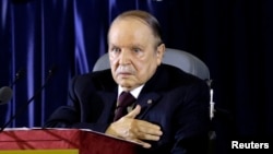 FILE - President Abdelaziz Bouteflika gestures during a swearing-in ceremony in Algiers, April 28, 2014. 