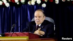 President Abdelaziz Bouteflika gestures during a swearing-in ceremony in Algiers, April 28, 2014. 