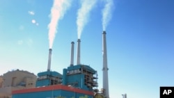 Smoke rises from power plant