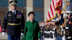 South Korean President Park Geun-hye second form left, reviews the troops during a full military honors parade to welcome her, Oct. 15, 2015, at the Pentagon.