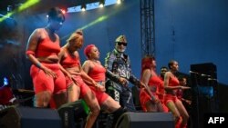 Le chanteur congolais originaire de la RDC, Koffi Olomidé, se produit sur la scène du festival de musique urbaine d'Anoumabo (Femua) à Abidjan, début septembre 2021. Il est entouré des chanteurs de son groupe et de ses danseuses. (Photo AFP / Kambou)