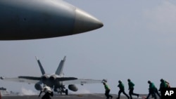 A U.S. Navy F-18 fighter jet takes off from the deck of the USS Carl Vinson (CVN 70) aircraft carrier following a routine patrol off the disputed South China Sea, March 3, 2017. 
