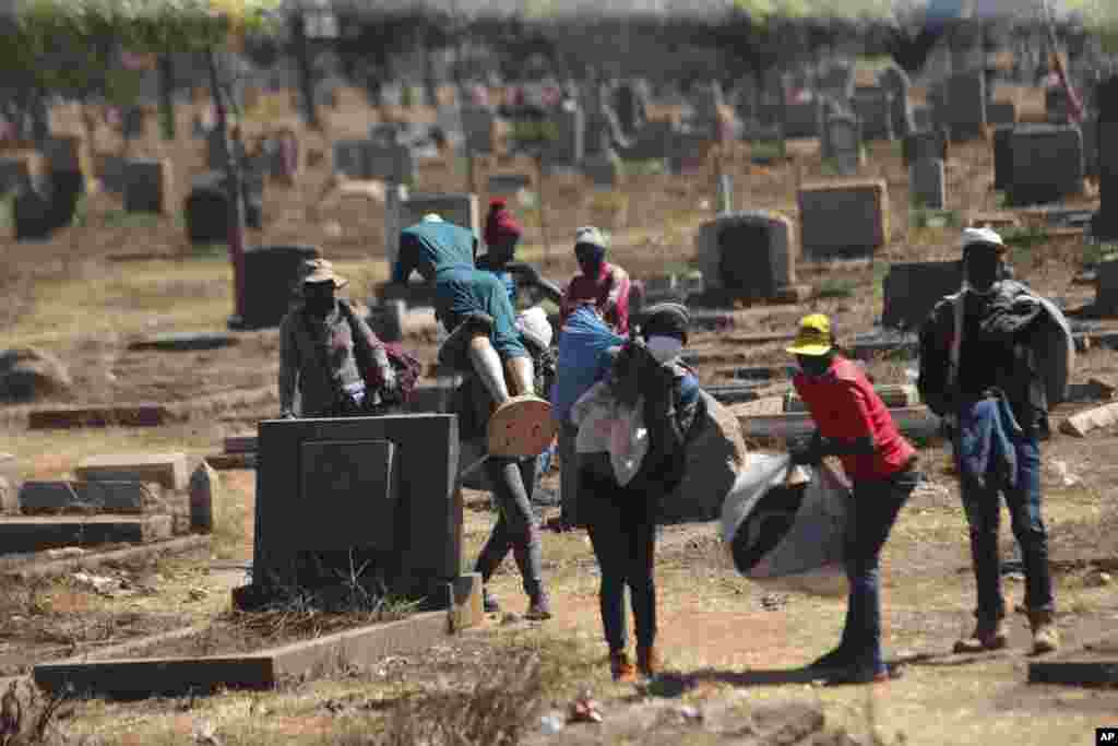 Zimbabwean vendors flee from the police who had chased them away after they were caught selling from undesignated areas due to COVID-19 restrictions in Harare.