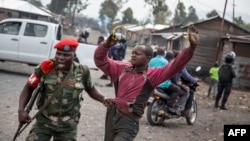 A man is arrested by a member of the military police after people attempted to block the road with rocks, in the neighborhood of Majengo in Goma, eastern Democratic Republic of the Congo, Dec. 19, 2016, as tensions rose with one day left of Congolese President Kabila's term.