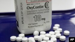 FILE - OxyContin pills, an opioid drug, are seen at a pharmacy in Montpelier, Vermont, Feb. 19, 2013. Americans, even though they comprise only five percent of the world's population, consume 80 percent of the its supply of pain medications.