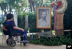 FILE - Former First Lady, now Congresswoman Imelda Marcos and Gov. Imee Marcos of northern Ilocos Norte province visit the gravesite of her late husband, former dictator Ferdinand Marcos at the Heroes Cemetery in observance of National Heroes Day, Aug. 28, 2017.