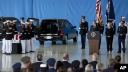 President Barack Obama, accompanied by Secretary of State Hillary Clinton, speaks during the Transfer of Remains Ceremony, September 14, 2012, at Andrews Air Force Base, Maryland.